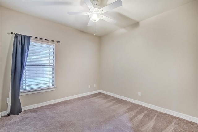 carpeted spare room with ceiling fan