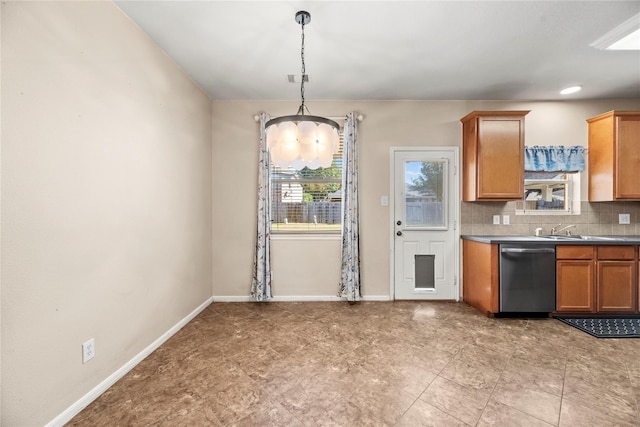 kitchen with backsplash, stainless steel dishwasher, sink, pendant lighting, and an inviting chandelier