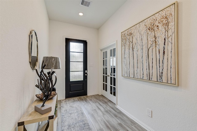 entrance foyer featuring light hardwood / wood-style floors and french doors