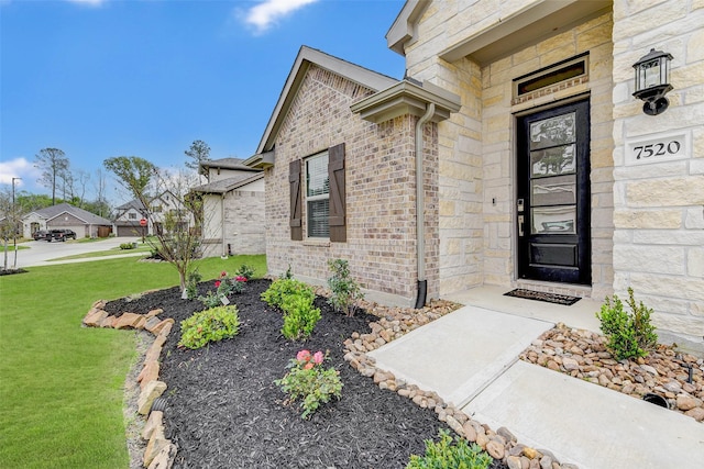 entrance to property featuring a lawn