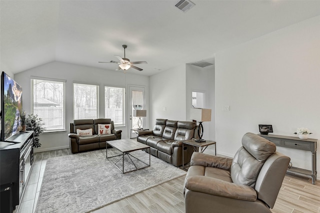 living room with ceiling fan, light hardwood / wood-style floors, and vaulted ceiling