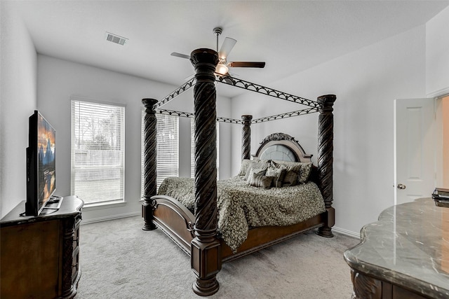 carpeted bedroom with multiple windows and ceiling fan