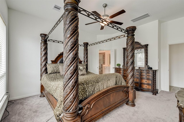 carpeted bedroom featuring ensuite bath and ceiling fan