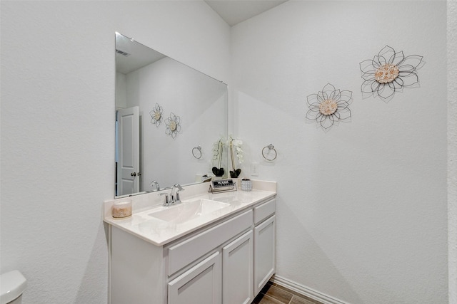 bathroom with vanity and toilet