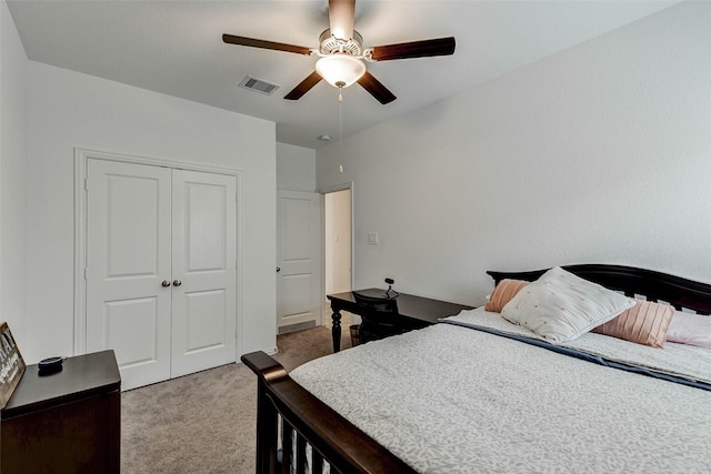 bedroom with a closet, light colored carpet, and ceiling fan