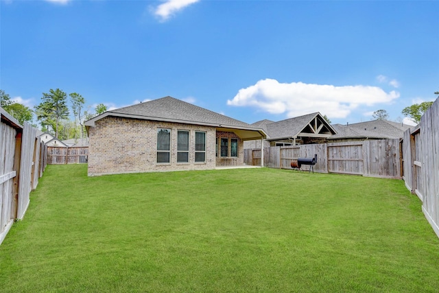 rear view of property with a yard