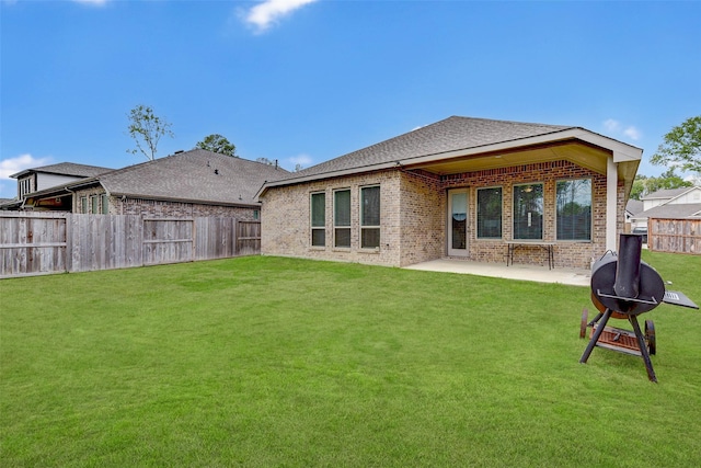 back of property featuring a patio area and a yard