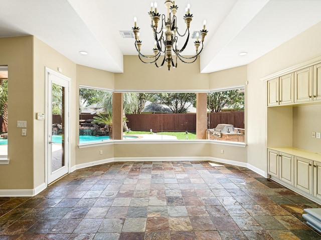 unfurnished dining area featuring a chandelier