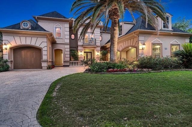 view of front of property with a balcony and a front yard