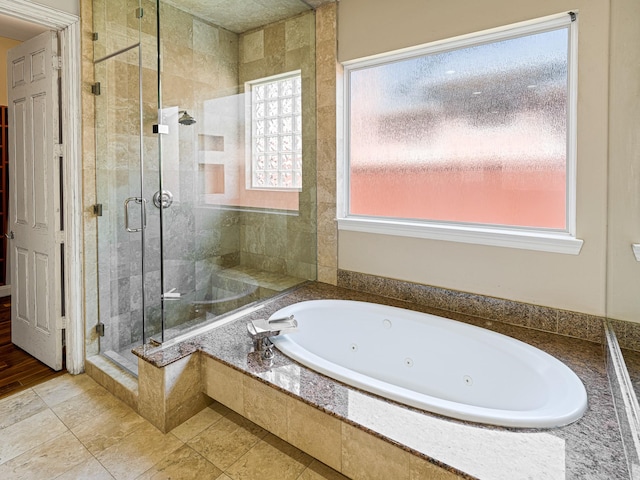 bathroom with tile patterned floors and independent shower and bath