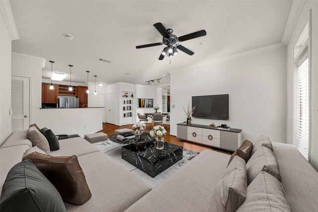 living room featuring ceiling fan, crown molding, and light hardwood / wood-style floors