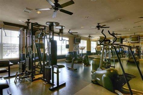 workout area with ceiling fan and visible vents