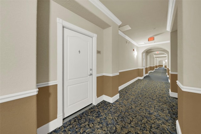 hall featuring carpet floors and crown molding