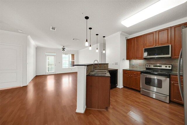 kitchen featuring pendant lighting, crown molding, sink, ceiling fan, and appliances with stainless steel finishes