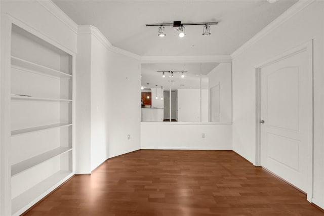 interior space featuring crown molding, dark hardwood / wood-style flooring, and rail lighting