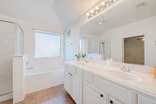 bathroom with tile patterned floors, vanity, lofted ceiling, and independent shower and bath