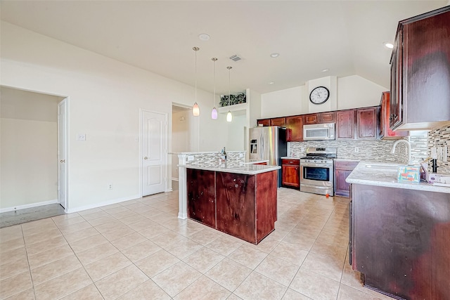 kitchen with a center island, sink, stainless steel appliances, backsplash, and decorative light fixtures