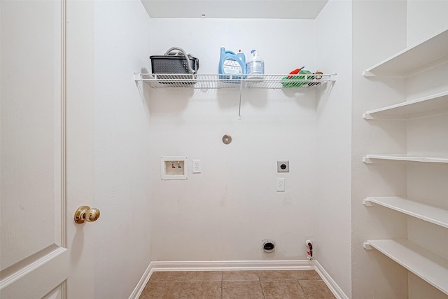 laundry area featuring electric dryer hookup, gas dryer hookup, light tile patterned floors, and hookup for a washing machine