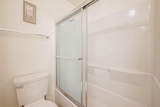 bathroom with enclosed tub / shower combo and toilet