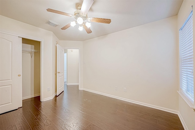 unfurnished bedroom featuring ceiling fan, a closet, and dark hardwood / wood-style floors