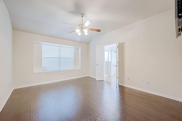 empty room featuring dark hardwood / wood-style floors, ceiling fan, and lofted ceiling