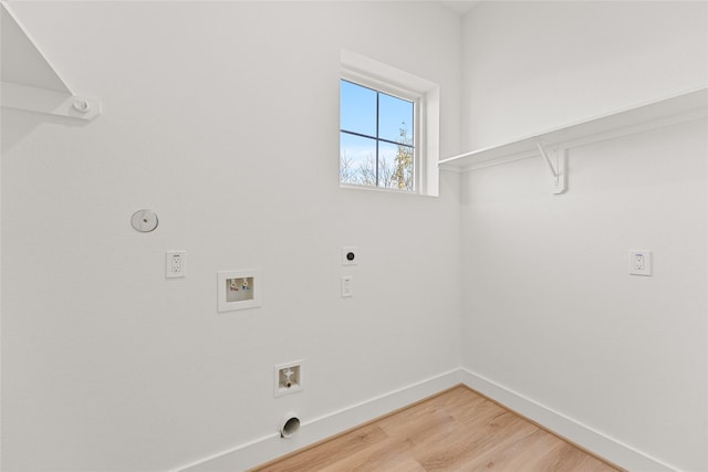 clothes washing area featuring hookup for an electric dryer, hookup for a washing machine, gas dryer hookup, and wood-type flooring