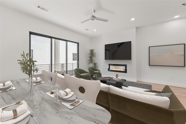 living room featuring wood-type flooring and ceiling fan