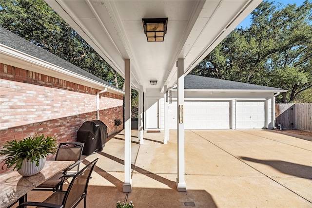 view of patio featuring a grill and a garage