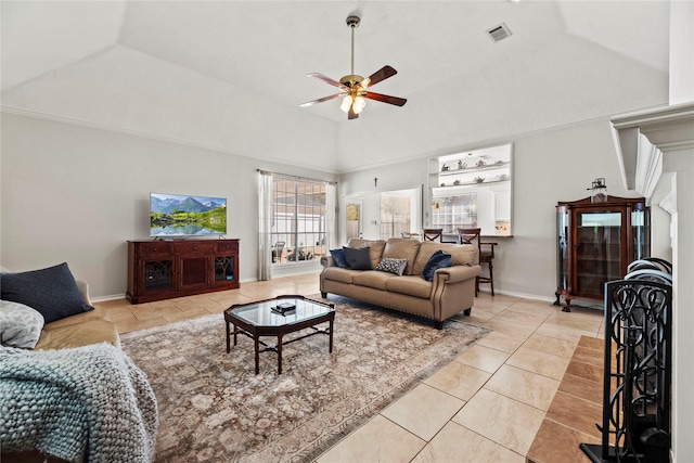 living room featuring ceiling fan, light tile patterned flooring, and lofted ceiling