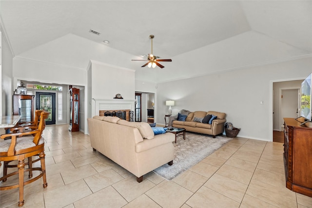 living room featuring ceiling fan, a raised ceiling, light tile patterned floors, and vaulted ceiling