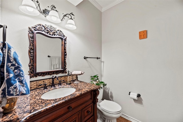 bathroom featuring vanity, toilet, and crown molding