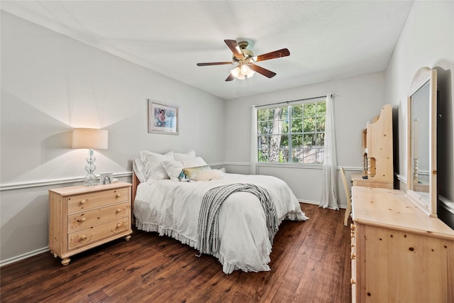 bedroom with dark hardwood / wood-style flooring and ceiling fan