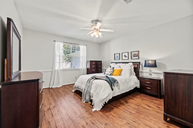 bedroom with ceiling fan and light hardwood / wood-style flooring