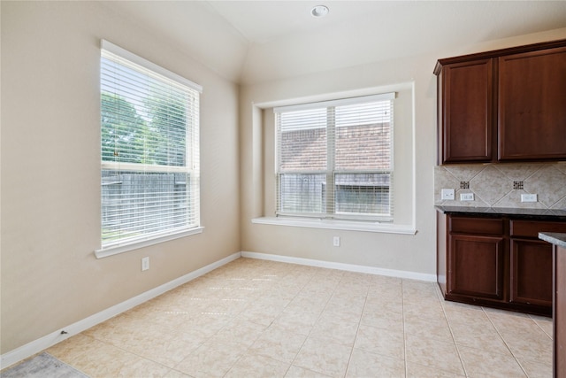 unfurnished dining area featuring light tile patterned floors