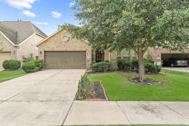 view of front of home featuring a front lawn and a garage