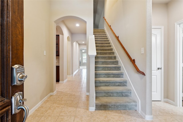 stairway with tile patterned flooring