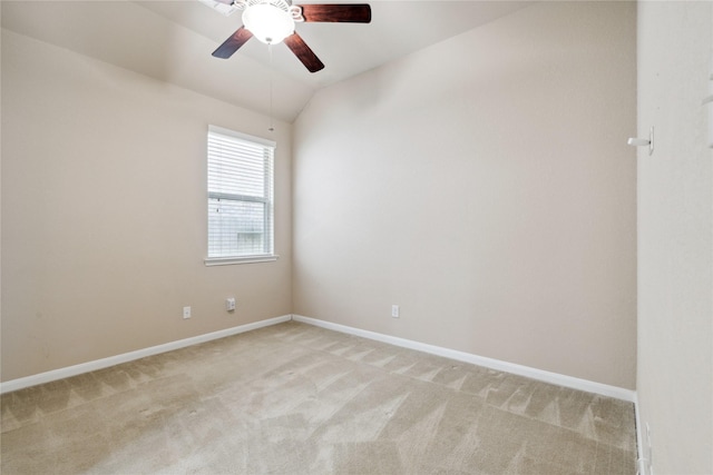 unfurnished room featuring light colored carpet, vaulted ceiling, and ceiling fan