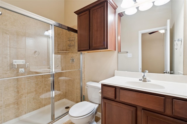 bathroom with vanity, toilet, and an enclosed shower