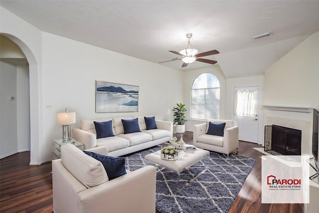 living room with vaulted ceiling, ceiling fan, and dark hardwood / wood-style flooring