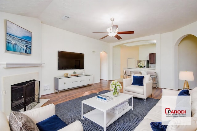 living room featuring ceiling fan and hardwood / wood-style flooring