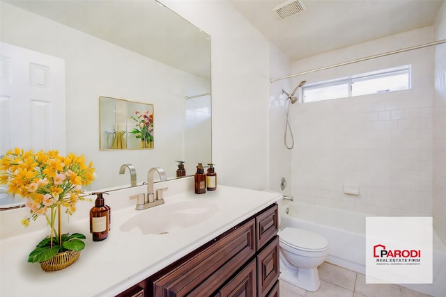 full bathroom featuring tile patterned floors, toilet, vanity, and tiled shower / bath