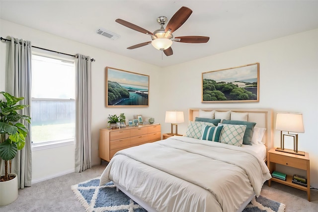 bedroom featuring light carpet and ceiling fan