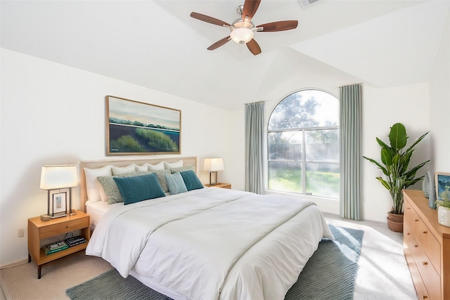 bedroom with vaulted ceiling, light colored carpet, and ceiling fan