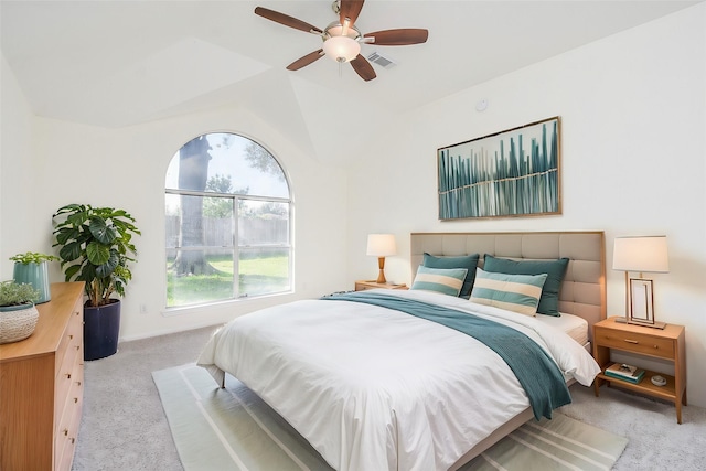 bedroom with vaulted ceiling, light colored carpet, and ceiling fan