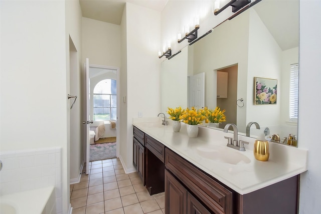 bathroom with vanity, a bath, and tile patterned flooring