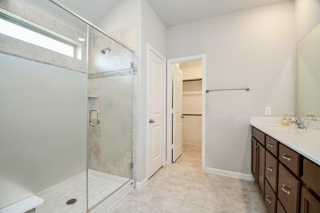 bathroom with vanity and a shower with door