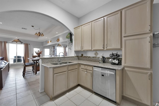 kitchen featuring light brown cabinetry, dishwasher, sink, and light tile patterned floors