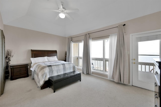 carpeted bedroom featuring a tray ceiling, ceiling fan, and vaulted ceiling