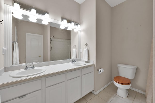 bathroom with tile patterned floors, vanity, and toilet