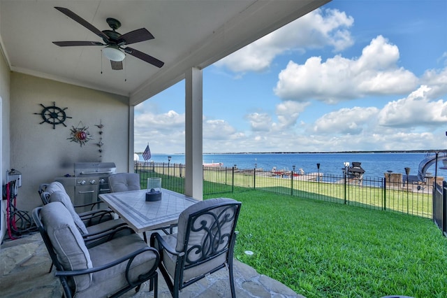 view of patio / terrace with a water view, area for grilling, and ceiling fan